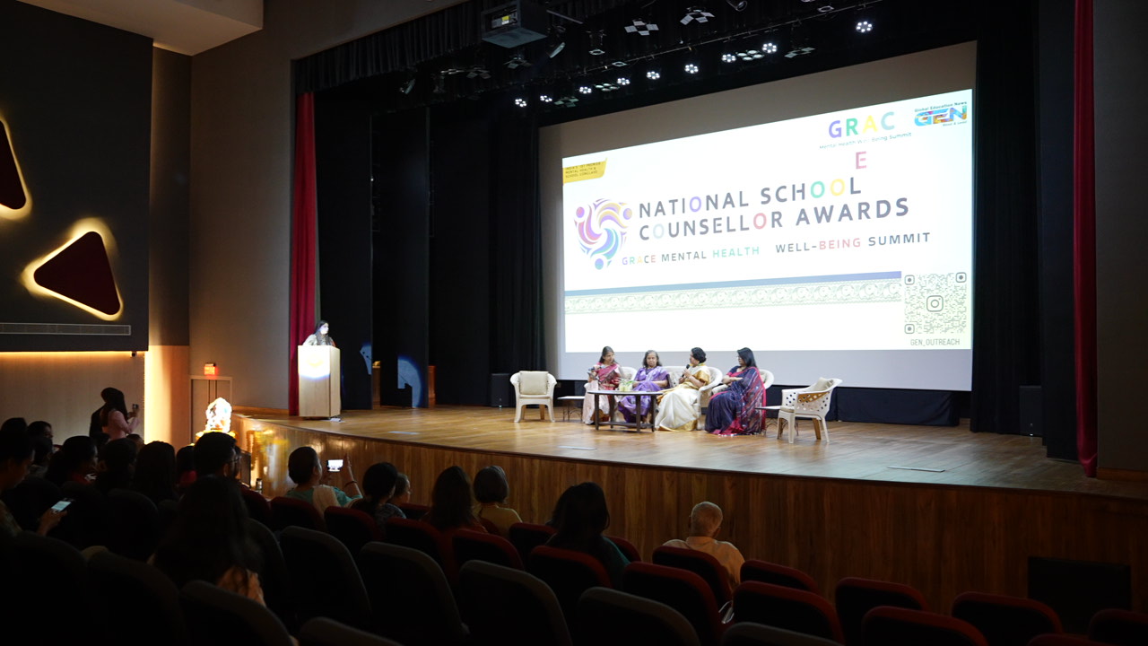 A group of children and young women participating in a panel discussion indoors